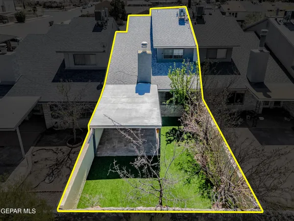 an aerial view of house with pool and yard