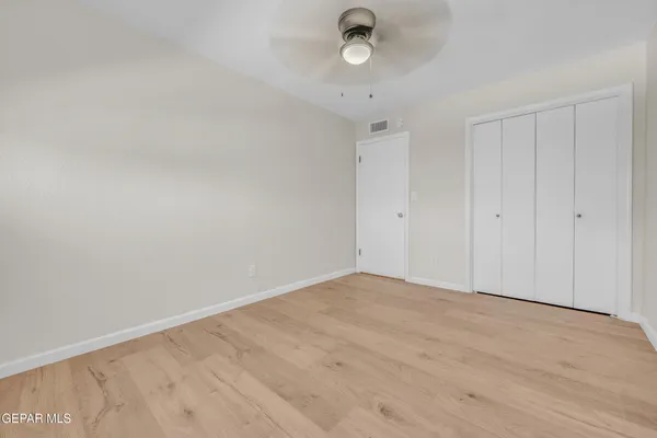 an empty room with a empty space and a ceiling fan