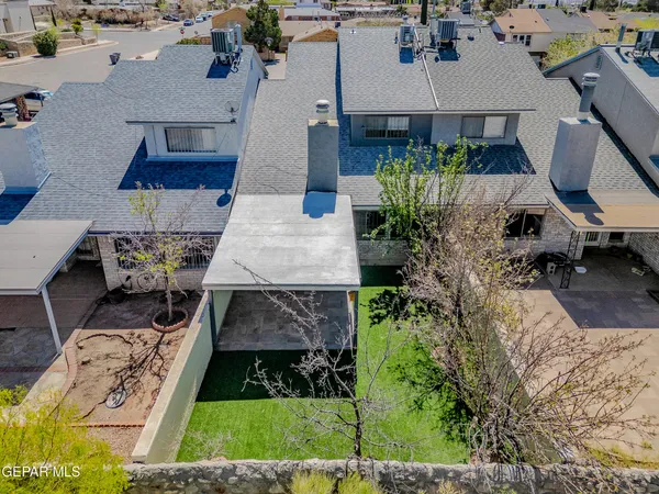 an aerial view of a house with yard and patio