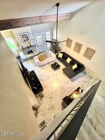a living room with furniture a flat screen tv and a large window