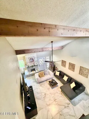 a living room with furniture and a chandelier
