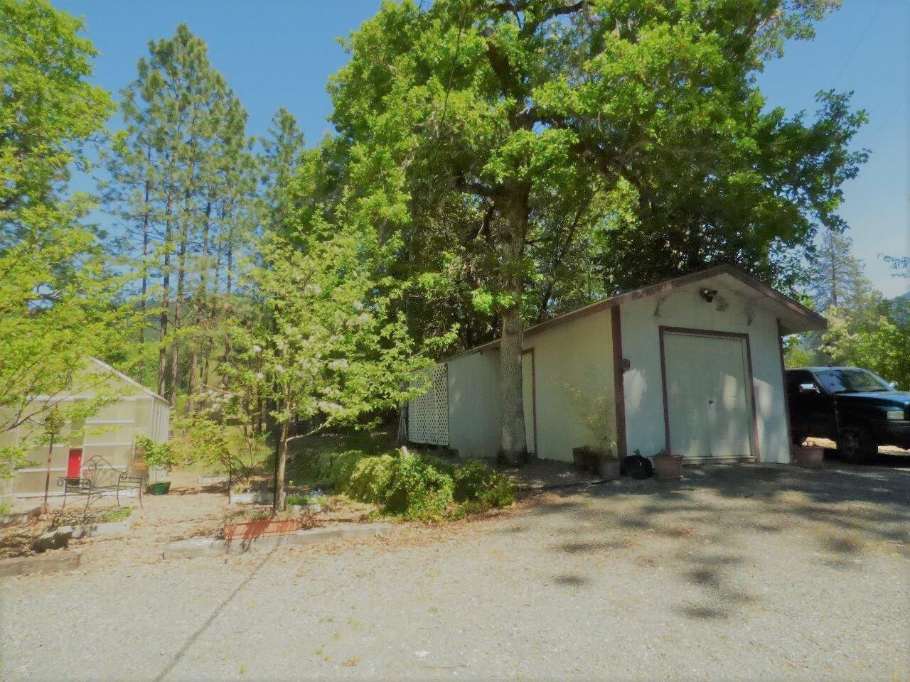 6520 Tunnel Loop Road Grants Pass, OR 97526 - Photo 47 of 69 a front view of a house with a yard and garage