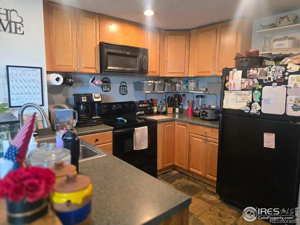 a kitchen with stainless steel appliances granite countertop a stove refrigerator sink and cabinets