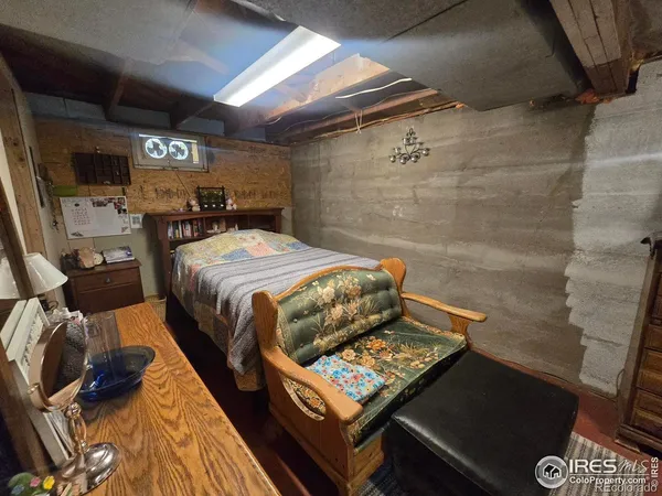 a bed sitting in a bedroom next to a tv