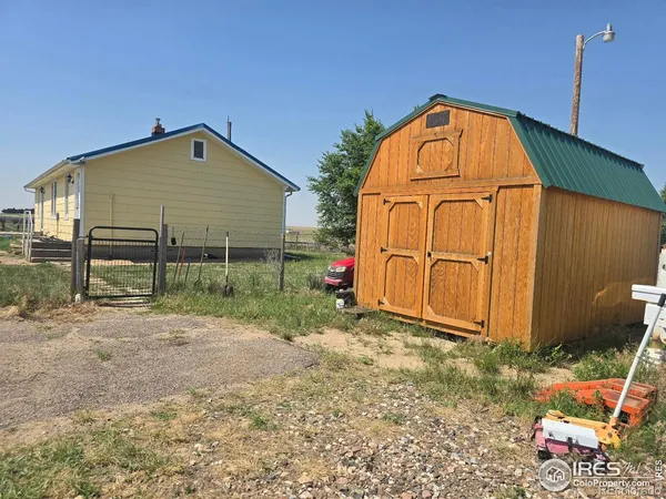 a view of backyard with small cabin