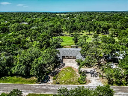 an aerial view of a house with a yard and garden