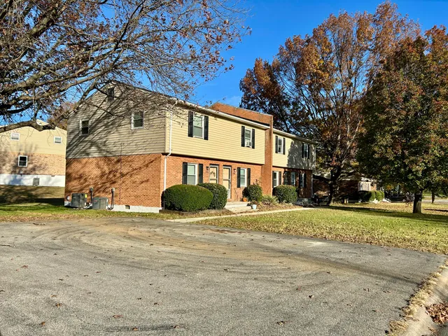 a view of a house with a yard and tree s