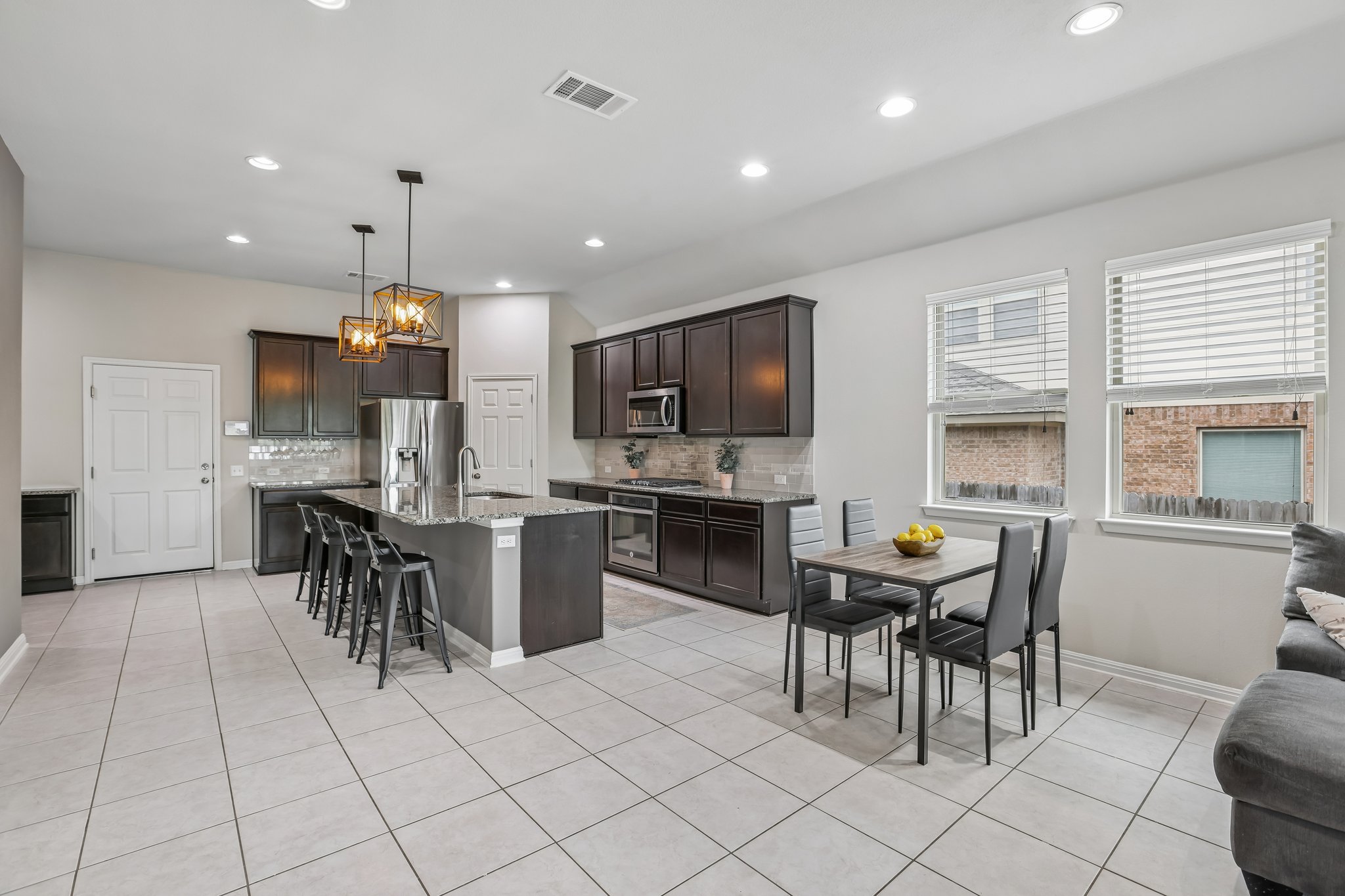 6801 Banff Cove Austin, TX 78754 - Photo 11 of 37 A well-lit kitchen featuring an expansive island, stainless steel appliances, and a seamless flow into the dining area