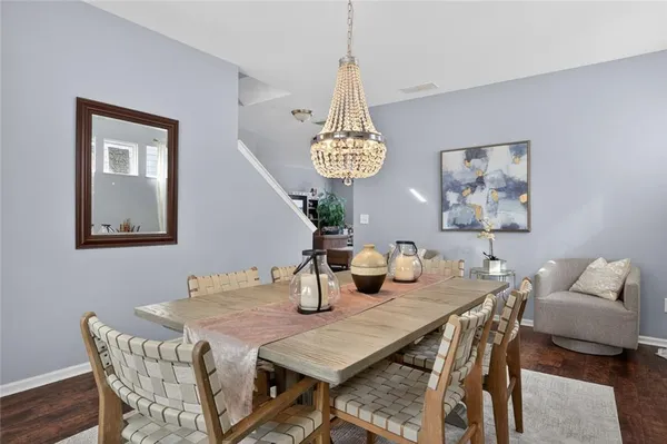 a view of a dining room with furniture and chandelier