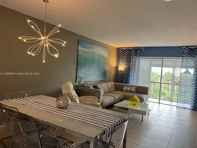 a living room with furniture a window and a ceiling fan