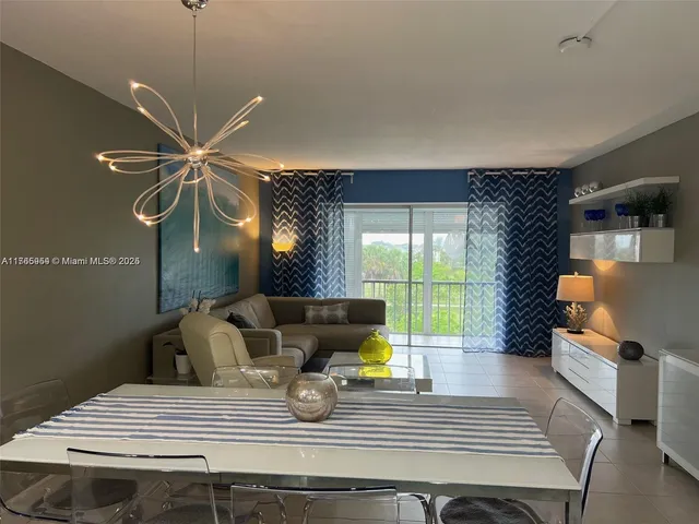 a view of a dining room with furniture and a chandelier