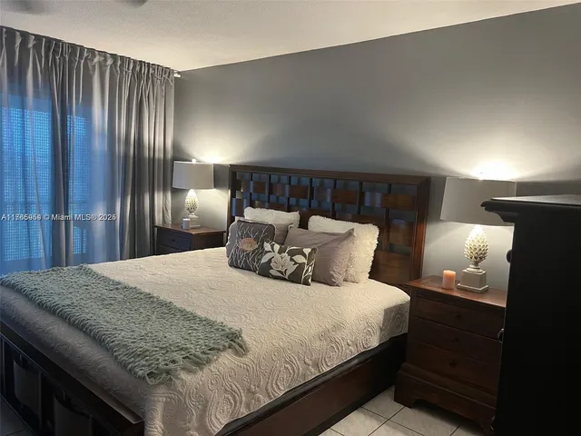 a bedroom with a bed and a night stand