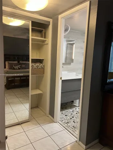 a kitchen with a refrigerator and a stove