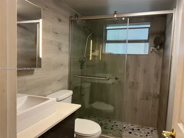 a bathroom with a shower and a toilet