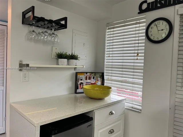 a view of a kitchen with a table and a chair