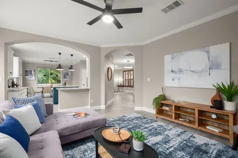 a living room with furniture and wooden floor
