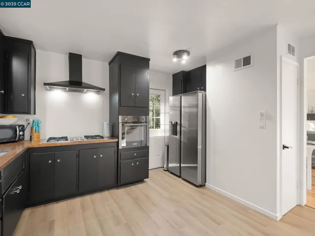 a kitchen with granite countertop a refrigerator and a sink