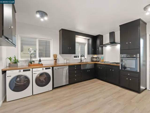 a kitchen with kitchen island wooden cabinets and sink