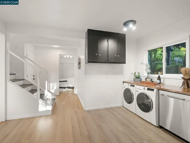 a view of a kitchen with a sink a microwave and cabinets