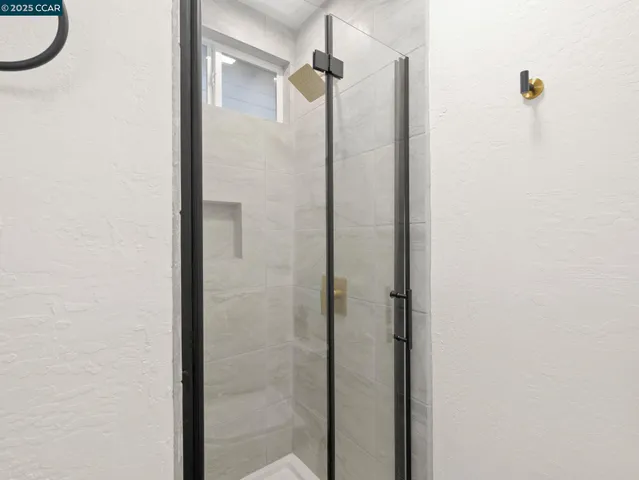 a bathroom with a shower and a mirror