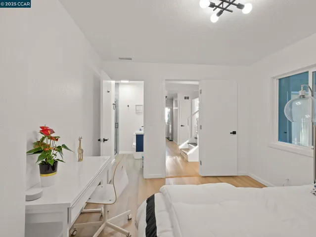 a bedroom with a bed and a chandelier