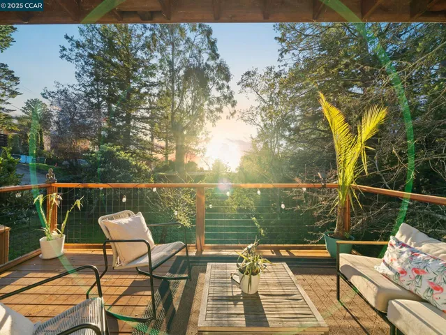 a view of a balcony with wooden floor and outdoor seating
