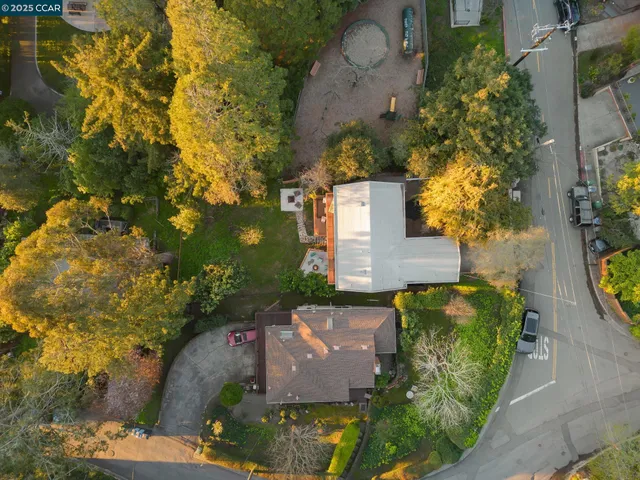 an aerial view of a house with a yard