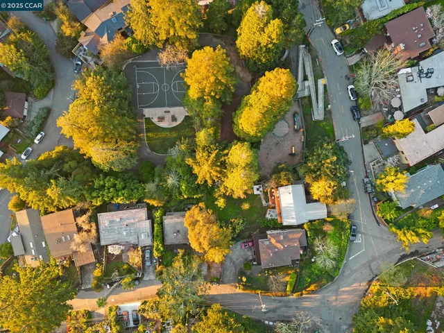 an aerial view of residential houses with outdoor space and street view