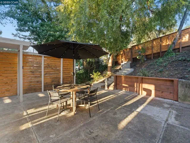 a view of an outdoor sitting area with brick walls