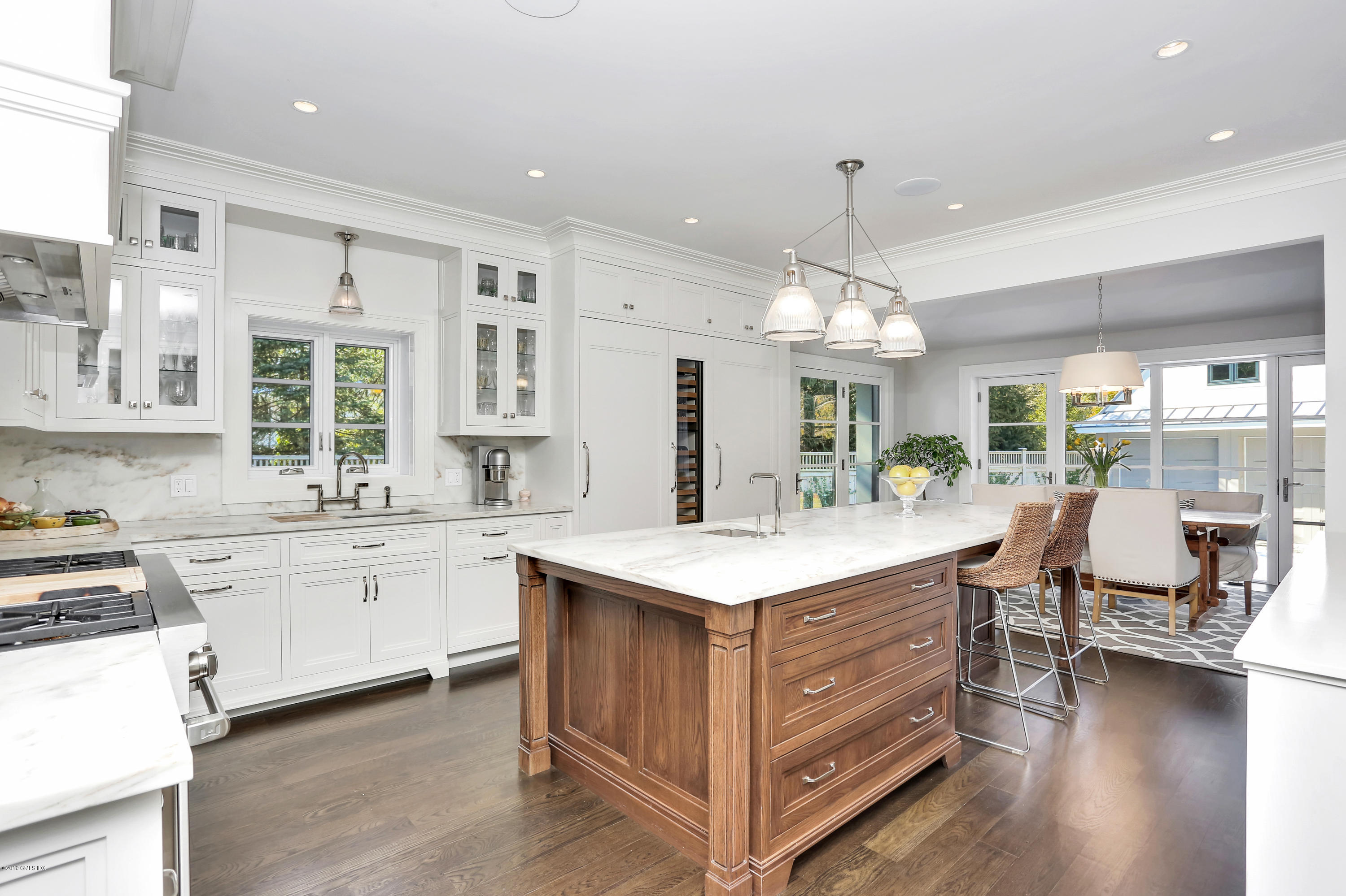 56 Old Church Road Greenwich, CT 06830 - Photo 11 of 41 a large kitchen with kitchen island a sink a center island a stove and a dining table view