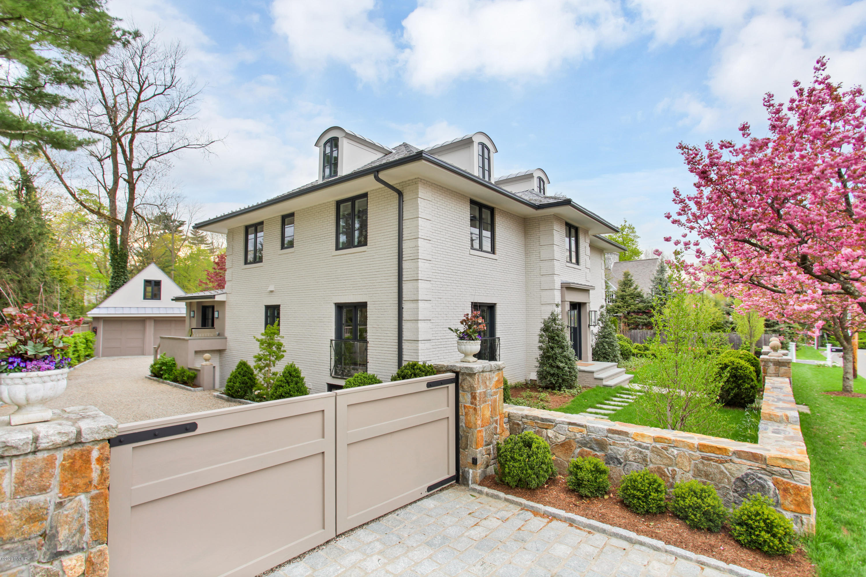56 Old Church Road Greenwich, CT 06830 - Photo 2 of 41 a view of a white house with a small yard and large trees