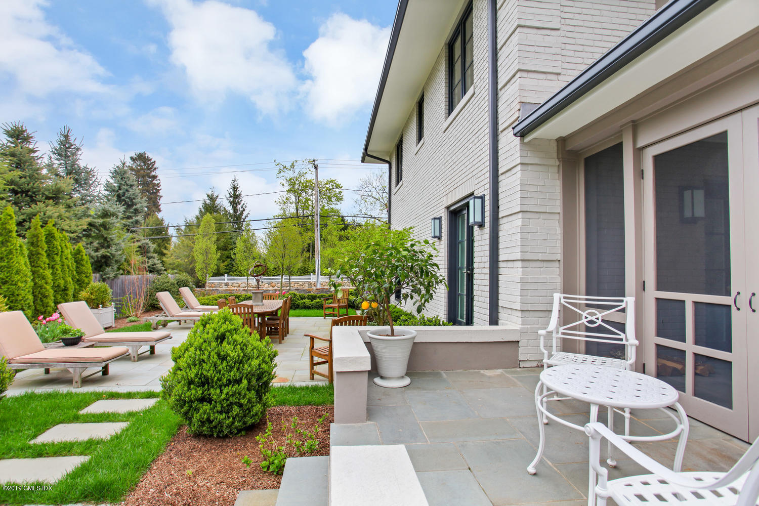 56 Old Church Road Greenwich, CT 06830 - Photo 29 of 41 a view of a patio with couches table and chairs and potted plants
