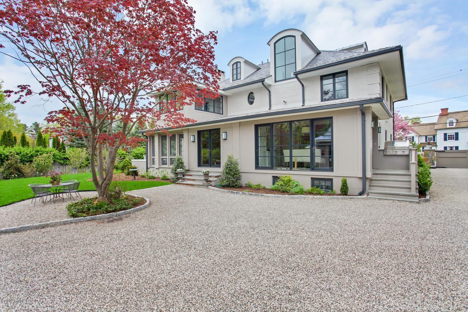 56 Old Church Road Greenwich, CT 06830 - Photo 32 of 41 a view of a brick house with a large windows and a large tree