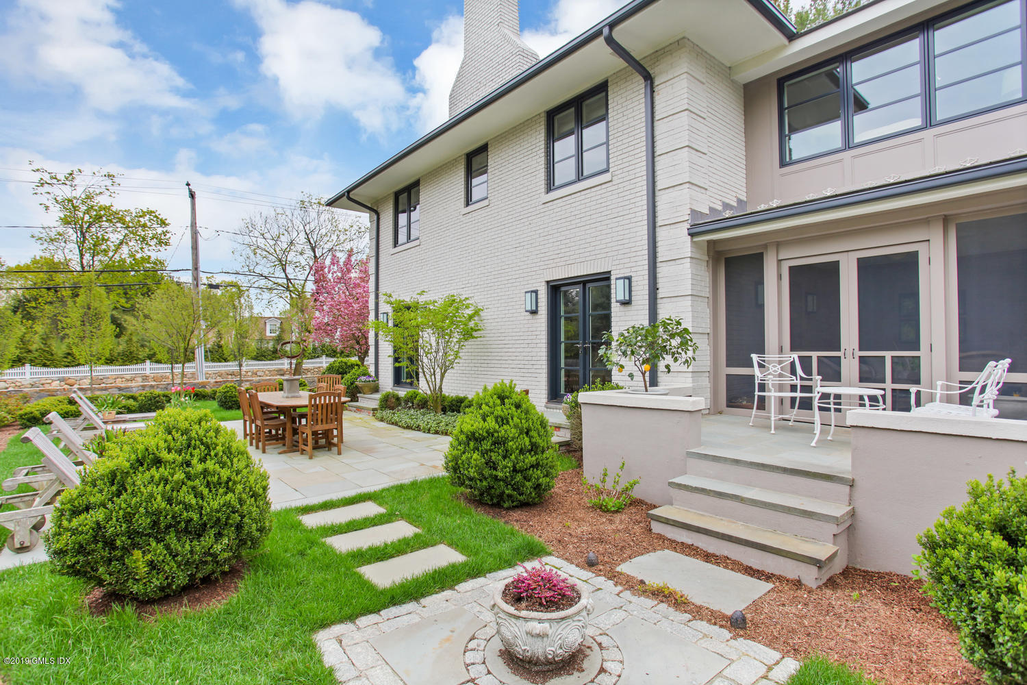 56 Old Church Road Greenwich, CT 06830 - Photo 8 of 41 a view of a patio with couches table and chairs and potted plants