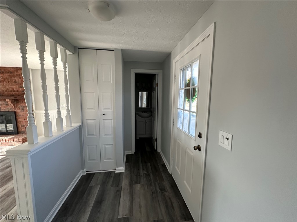 16213 Drake Road Strongsville, OH 44136 - Photo 3 of 28 Hall with dark wood-type flooring and a textured ceiling