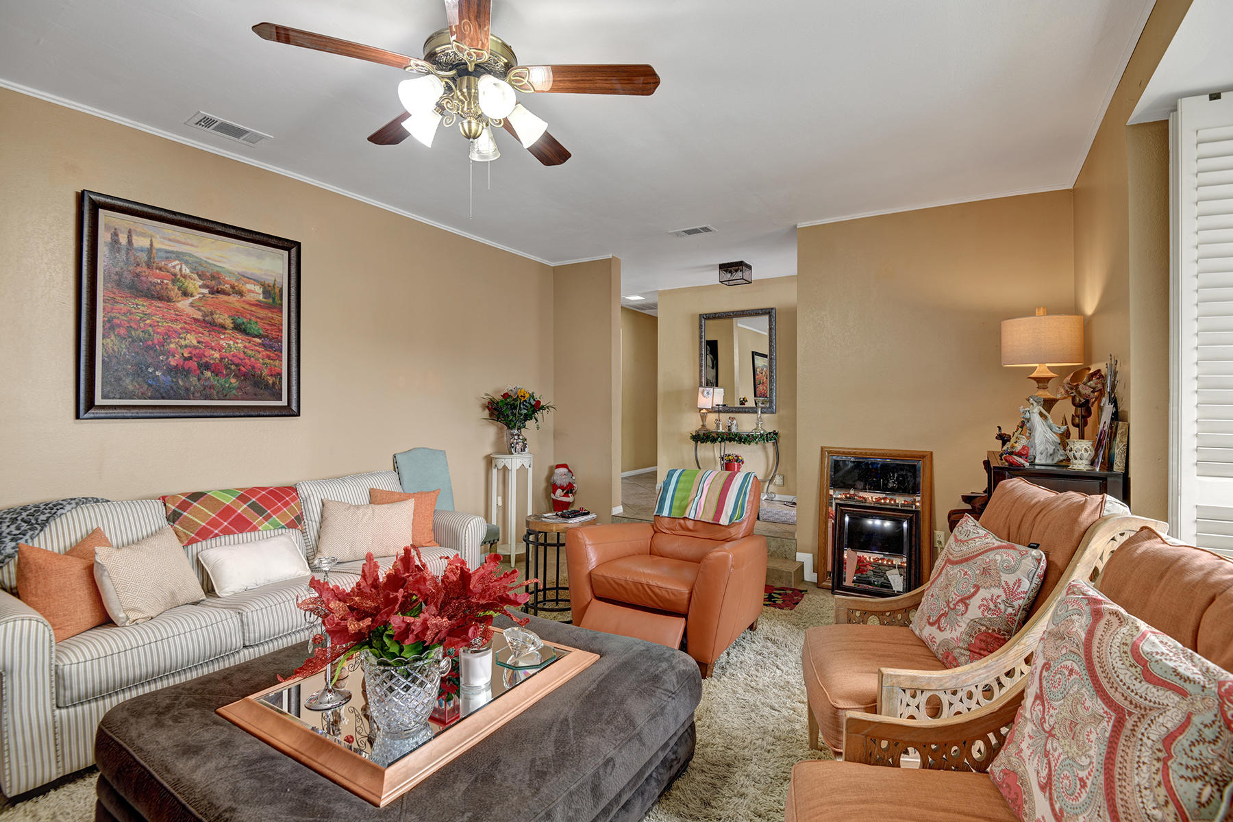 81850 Victoria Street Indio, CA 92201 - Photo 4 of 17 a living room with furniture a chandelier and a potted plant