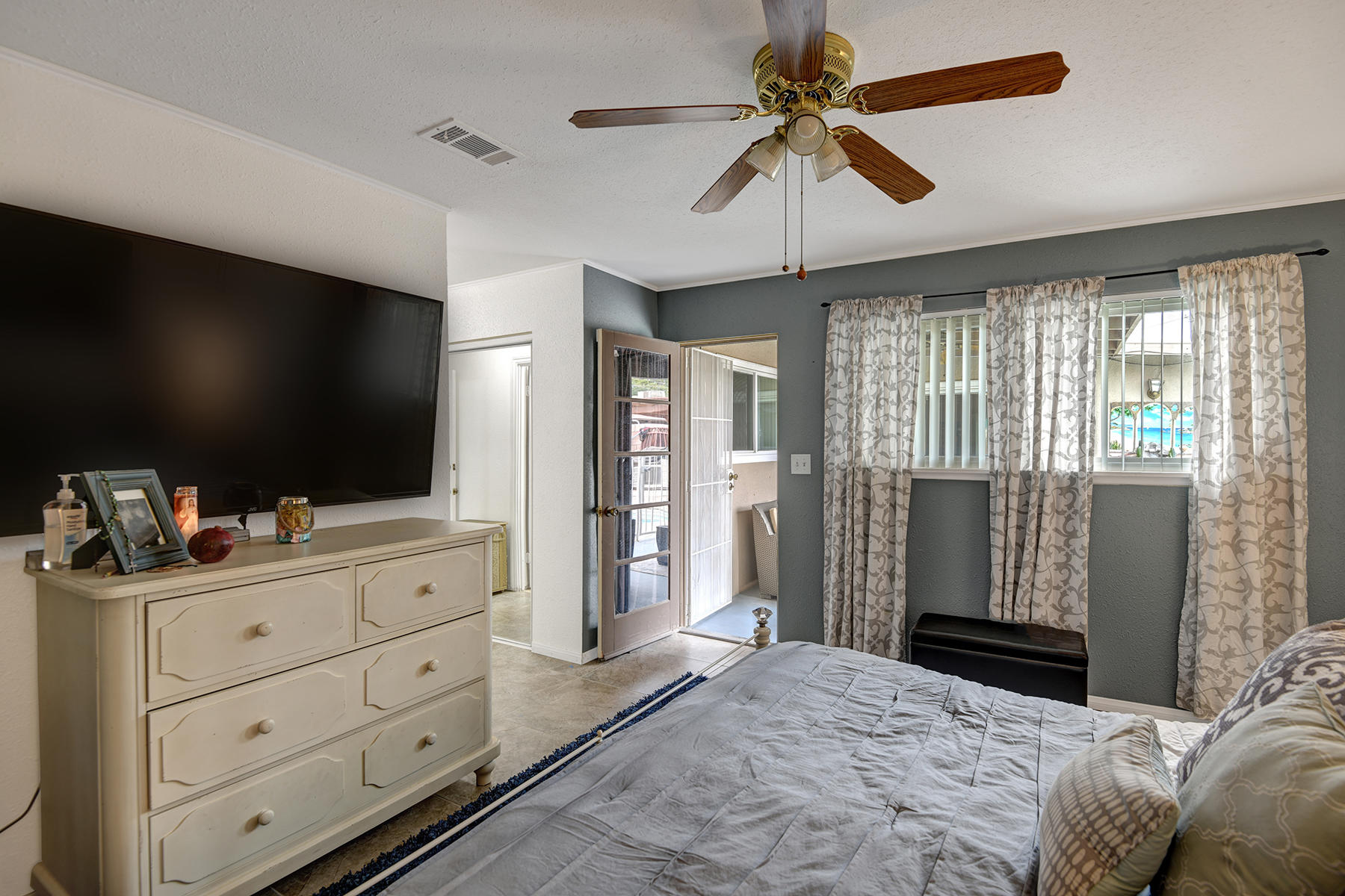 81850 Victoria Street Indio, CA 92201 - Photo 7 of 17 a bedroom with a bed and a flat screen tv