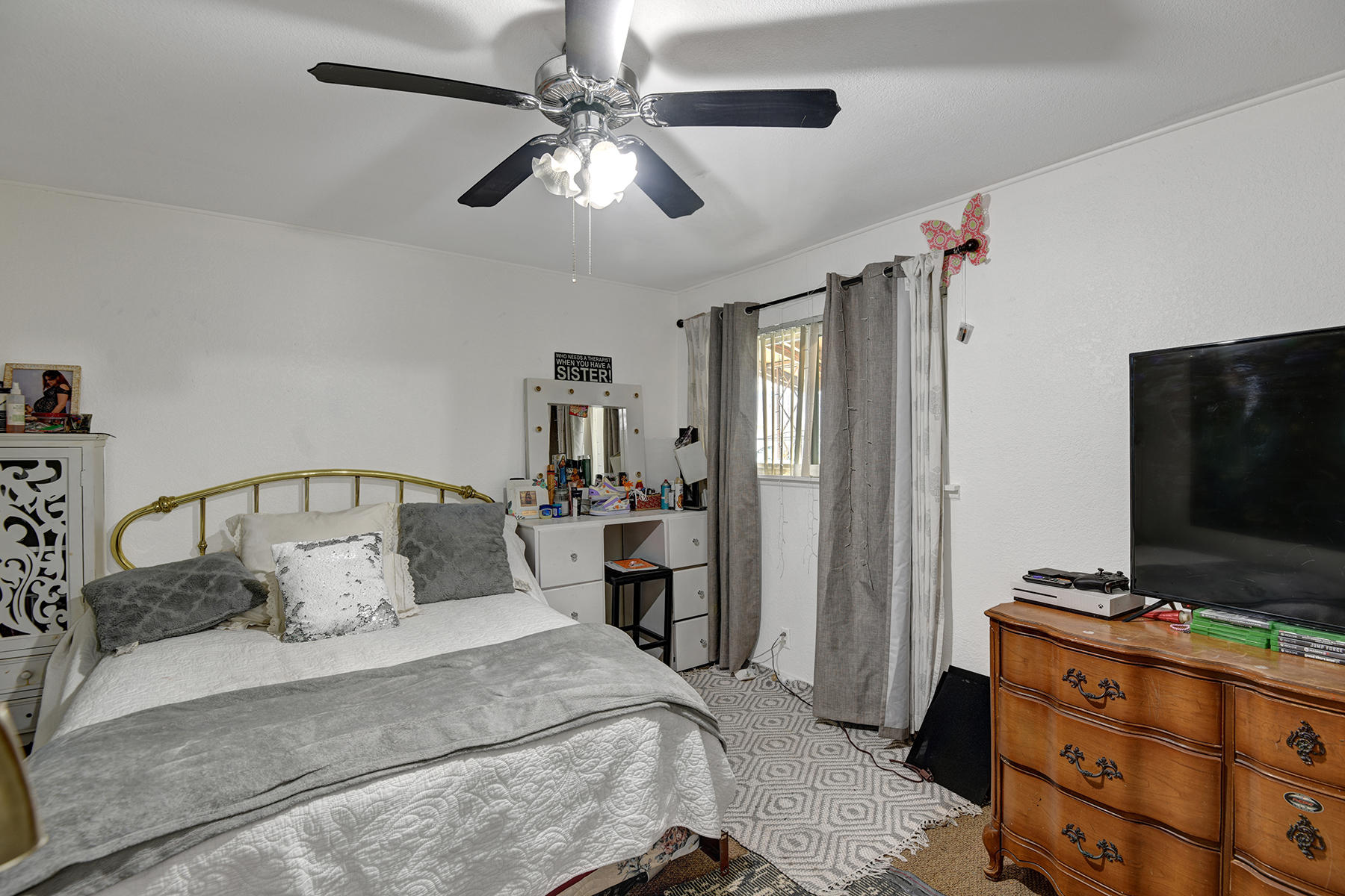 81850 Victoria Street Indio, CA 92201 - Photo 10 of 17 a bedroom with a bed and a flat tv screen on dresser