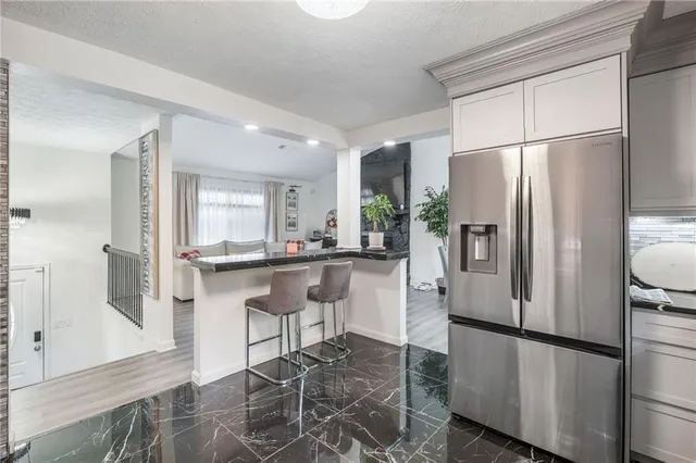 a kitchen with stainless steel appliances a refrigerator and a stove top oven