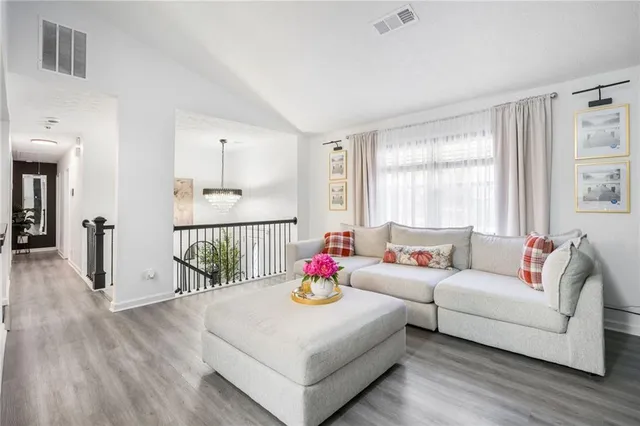 a living room with furniture and wooden floor