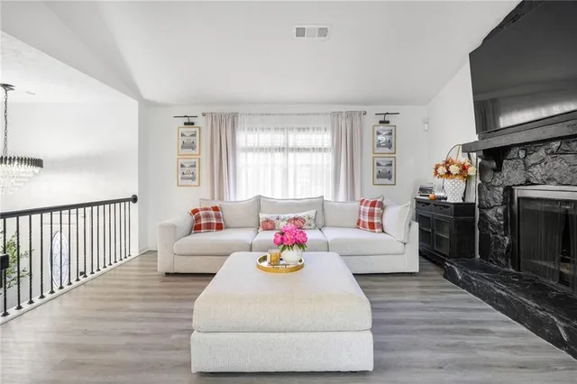 a living room with furniture fireplace and flat screen tv