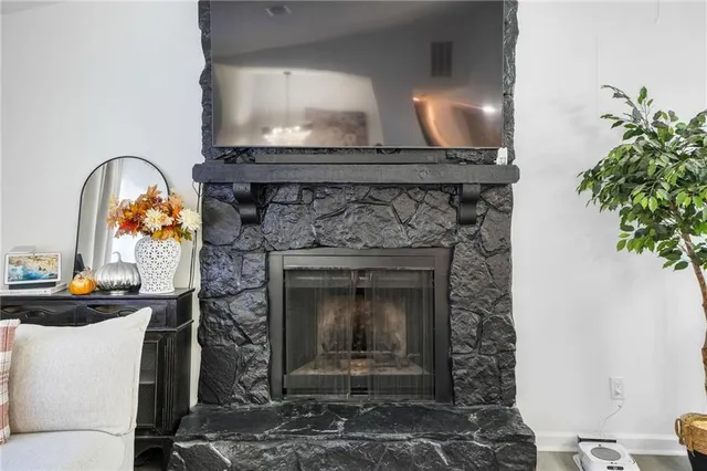 a fireplace with a vase of flowers on it