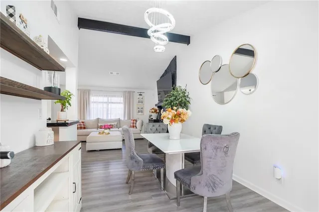 a living room with dining table furniture and a mirror