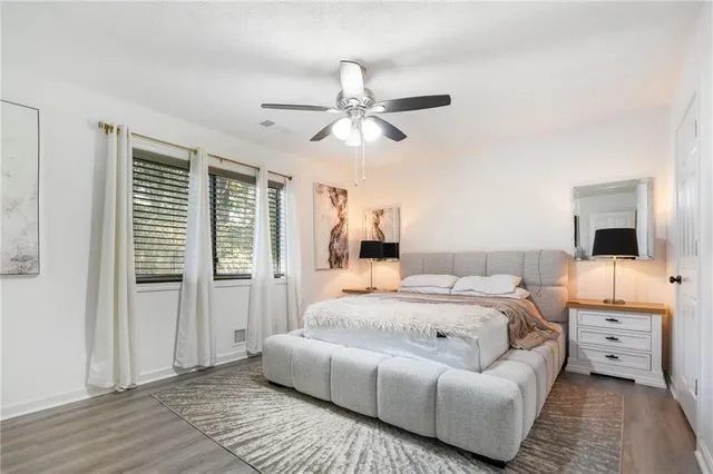 a bedroom with a large bed and a chandelier