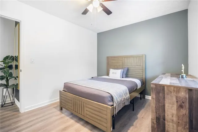 a bedroom with a bed and a potted plant