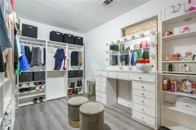 a room with a wooden floor and cabinets