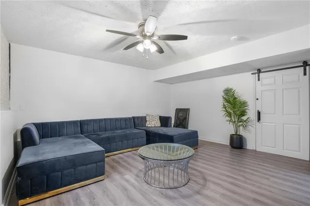 a living room with furniture and a wooden floor