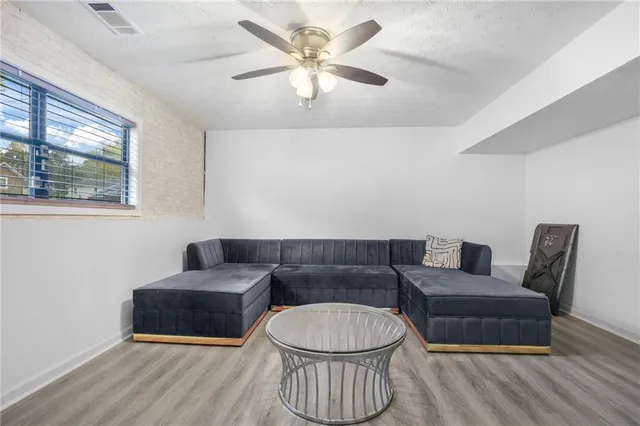 a living room with furniture and a wooden floor