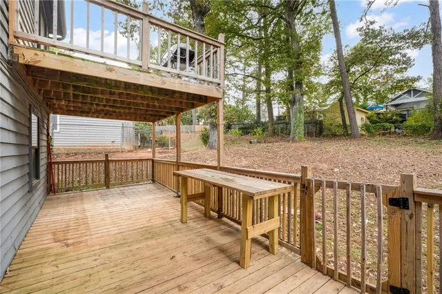 a view of a house with a wooden deck