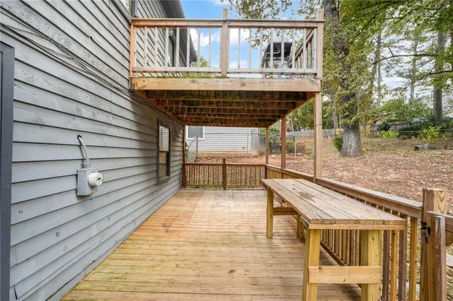 a view of balcony with wooden floor and fence